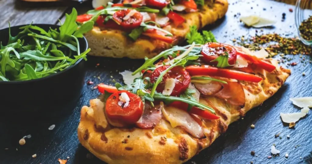 Close-up of a Pickle Pie Pizza featuring tangy pickles, gooey cheese, and a golden-brown crust for a creative and flavorful twist on pizza